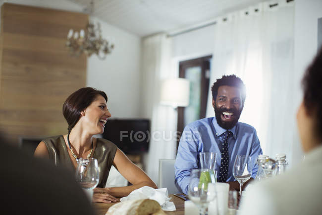Friends laughing at dinner party — Stock Photo