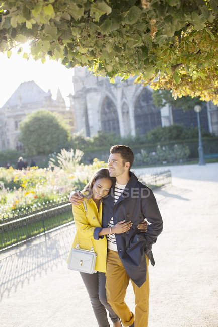 Couple walking together in urban park — Stock Photo