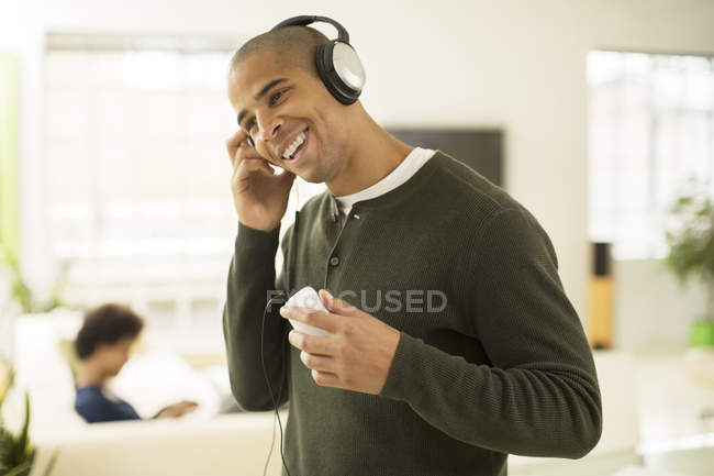 Чоловік слухає навушники у вітальні — стокове фото