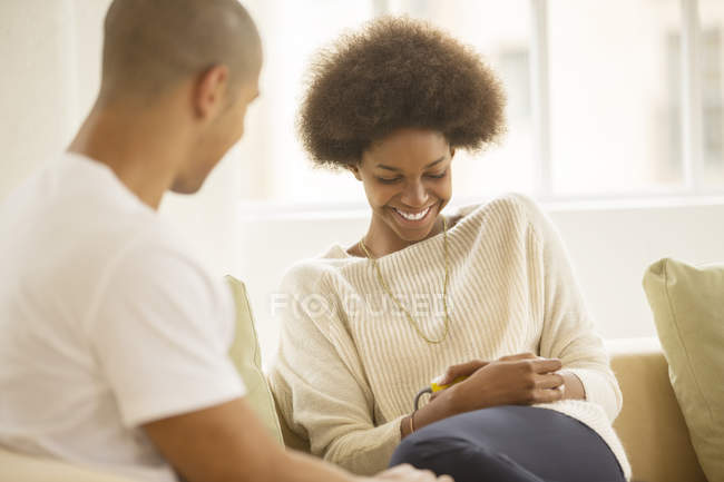 Couple relaxing together on sofa at home — Stock Photo