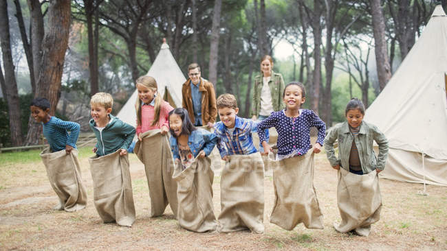 Children having sack race at campsite — Stock Photo
