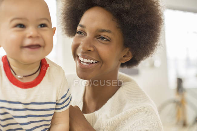 Mother holding baby boy at home — Stock Photo