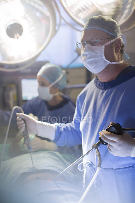Surgeon performing laparoscopic surgery in operating theater — Stock Photo
