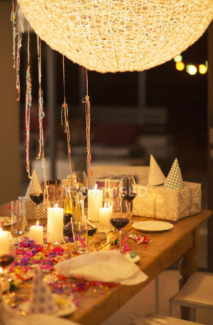 Candles and gifts on table at birthday party — Stock Photo
