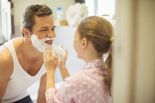 Девушка натирает лицо кремом для бритья — стоковое фото