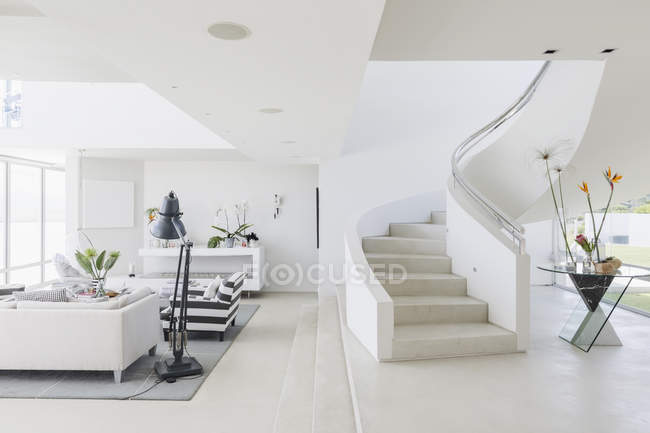 White modern luxury home showcase spiral staircase and living room — Stock Photo