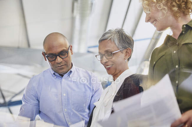 Business people discussing paperwork in meeting — Stock Photo