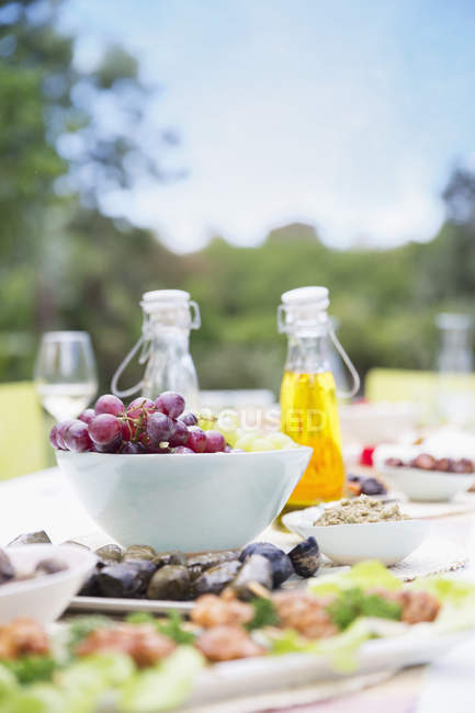 Plates of food on table outdoors — Stock Photo