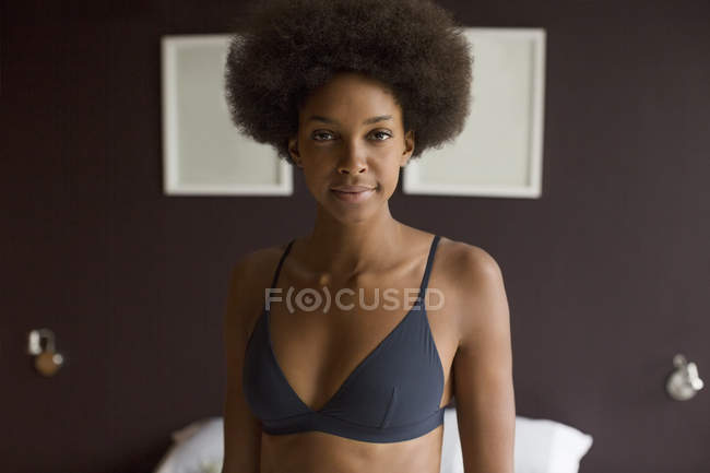Woman wearing bra in bedroom at home — Stock Photo