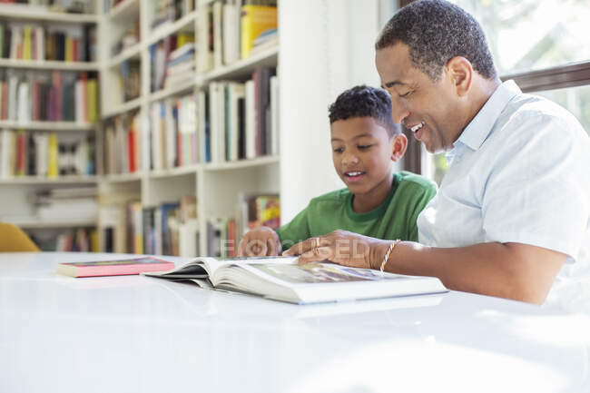 Grandfather and grandson reading book — Stock Photo
