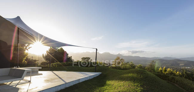 Tranquil, sunny luxury patio with view — Stock Photo