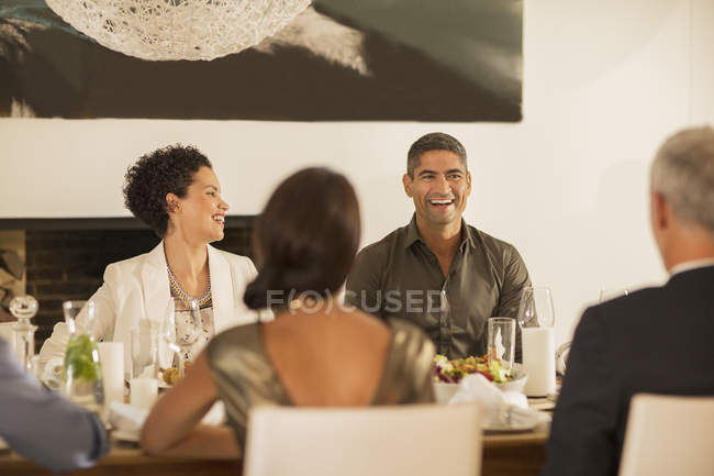 Friends laughing at dinner party — Stock Photo