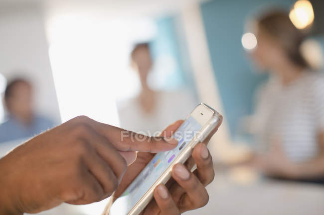 Close up businessman touching, using smart phone in meeting — Stock Photo