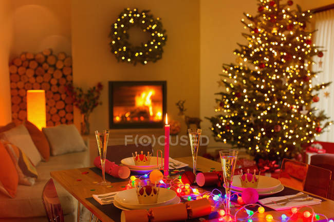 Mesa de jantar de Natal ambiente na sala de estar com lareira e árvore de Natal — Fotografia de Stock