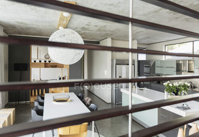 Blick auf modernes Esszimmer und Küche durch Holzlatten — Stockfoto