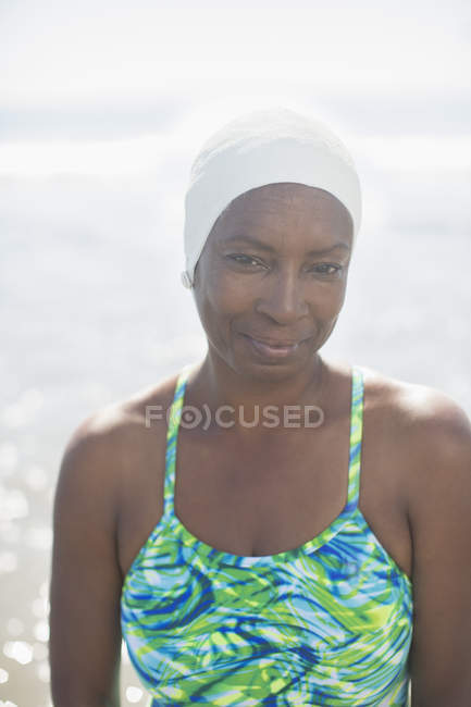 Portrait of serious woman in bathing suit and cap — Stock Photo