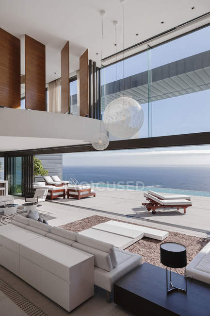 Living room  interior in modern house overlooking ocean — Stock Photo