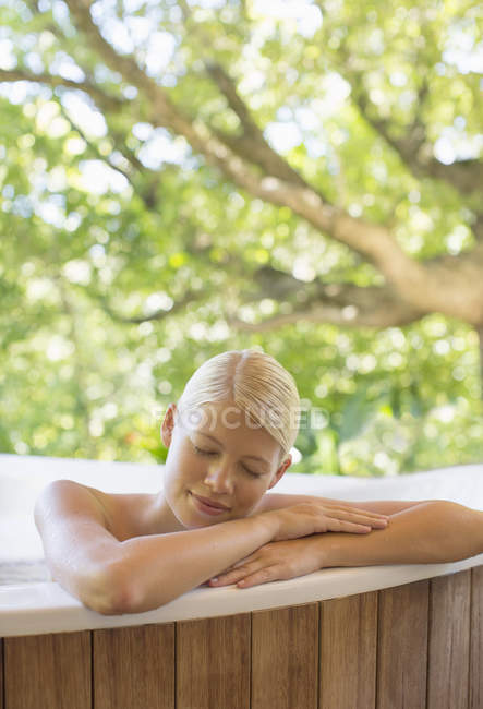 Woman relaxing in hot tub — Stock Photo