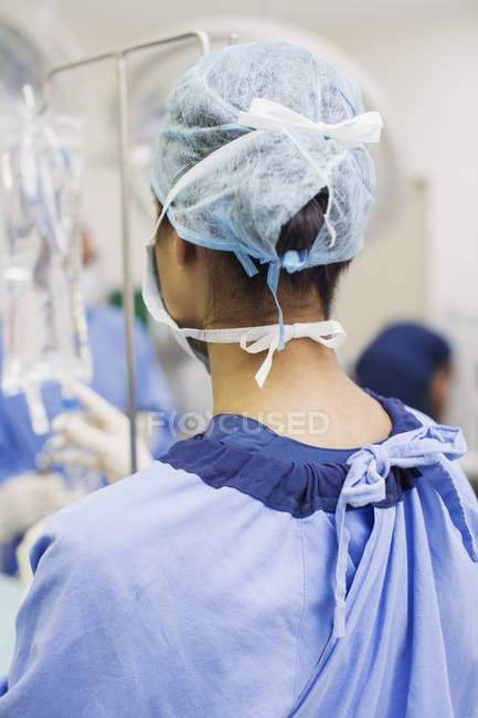 Задній вид жіночий хірург стоять в операційної театру — стокове фото