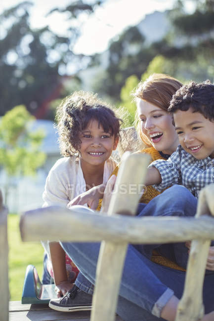 Students and teacher sitting outdoors — Stock Photo