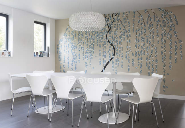 Wall art and chandelier in modern dining room — Stock Photo