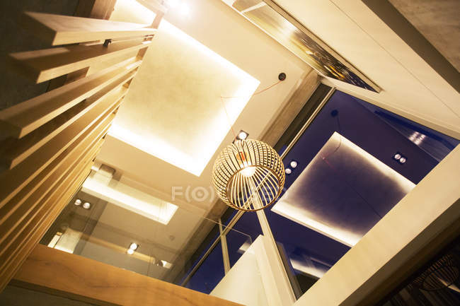 Illuminated tray ceiling and modern pendant light hanging in luxury foyer — Stock Photo