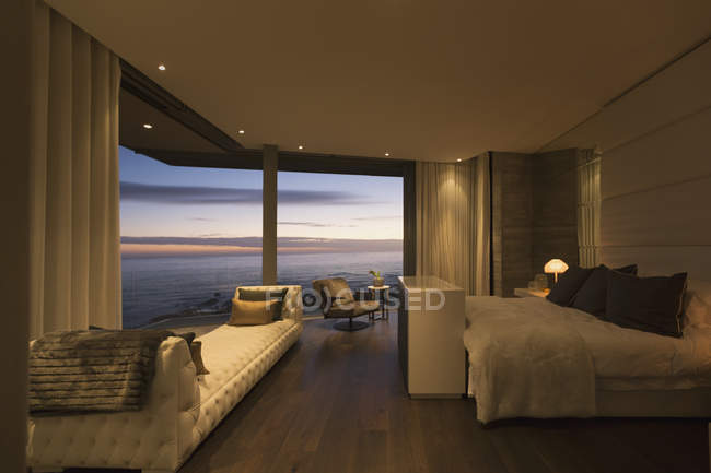 Twilight ocean view beyond luxury home showcase bedroom — Stock Photo