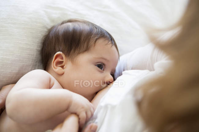 Mother breast-feeding baby girl, closeup — Stock Photo