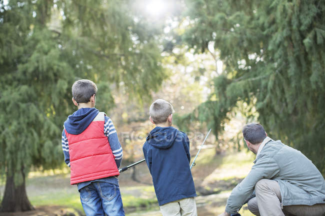 Father and sons fishing in woods together — Stock Photo