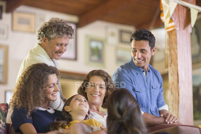 Happy beautiful family gathered on the couch together — Stock Photo