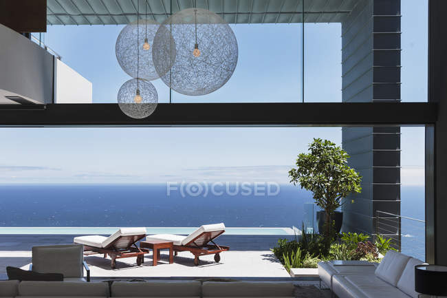 Lounge chairs on balcony overlooking ocean — Stock Photo
