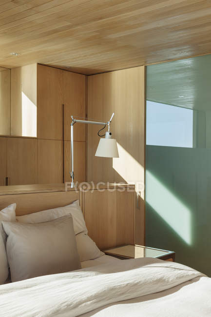 Lamp over bed indoors — Stock Photo