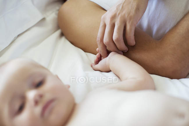 Father holding baby's hand — Stock Photo