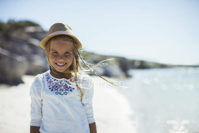 Young girl smiling on beach — Stock Photo