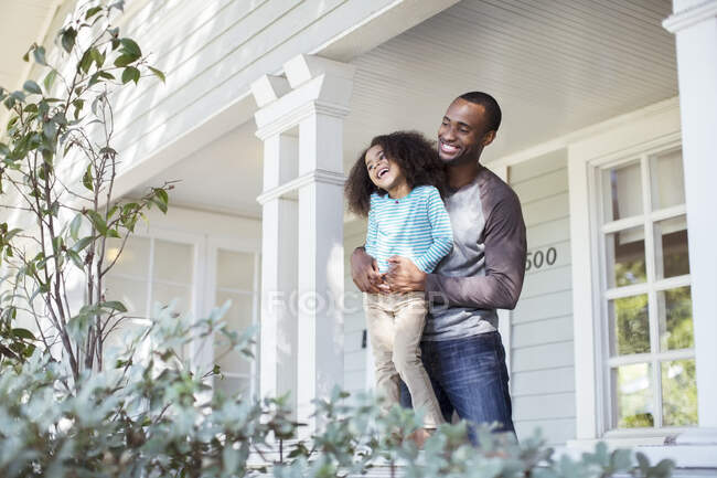 Happy father and daughter on porch — Stock Photo