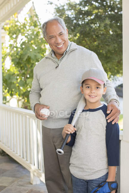 Portrait of grandfather and grandson with baseball and bat — Stock Photo