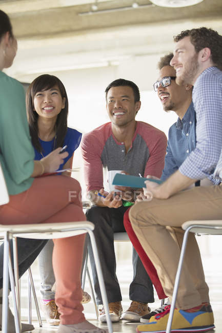 Creative business people meeting in circle of chairs — Stock Photo