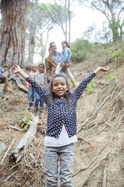 Girl holding arms out in forest — Stock Photo