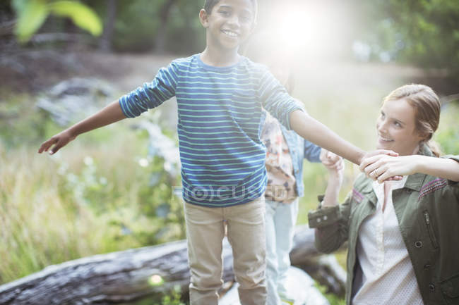 Teacher and student playing in forest — Stock Photo