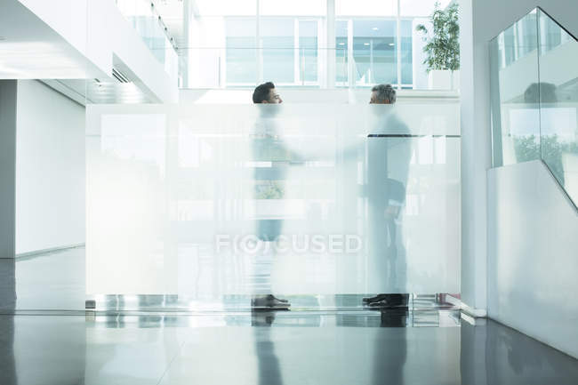 Businessmen talking in modern office — Stock Photo