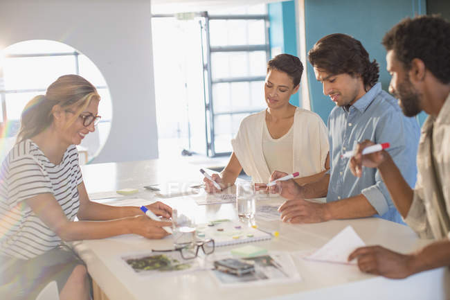 Creative business people brainstorming, drawing in conference room meeting — Stock Photo