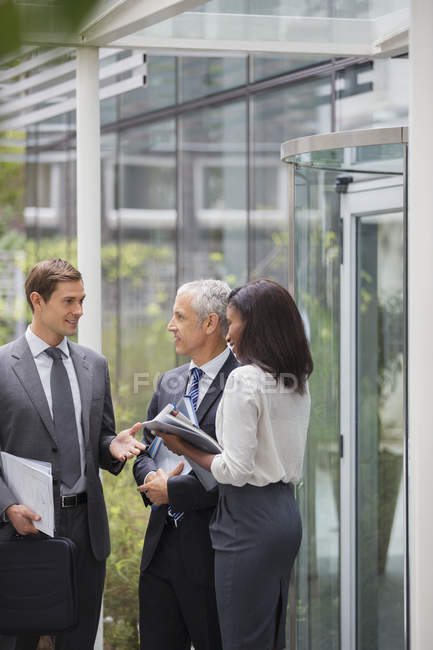 Business people talking outside of office building — Stock Photo