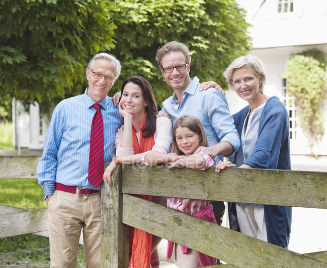 Familie lächelt gemeinsam am Holzzaun — Stockfoto