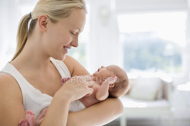 Mother cradling newborn baby — Stock Photo