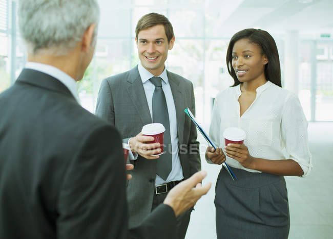 Business people talking in office building — Stock Photo