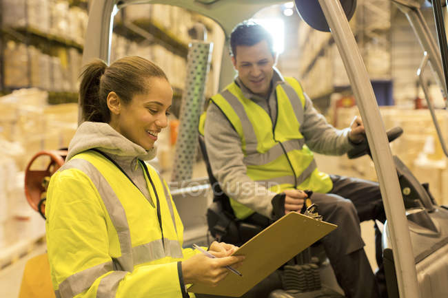 Workers talking in warehouse — Stock Photo