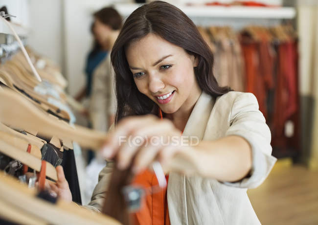 Woman shopping in clothes store — Stock Photo