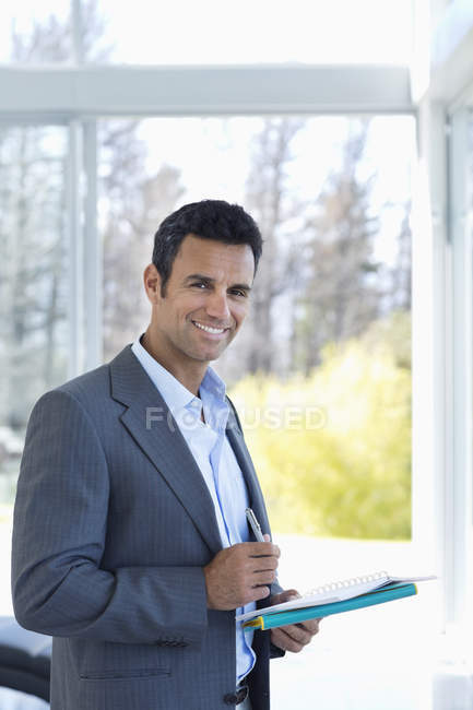 Businessman reading papers at modern office — Stock Photo