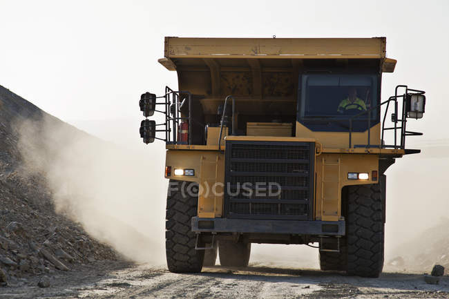 Machinery driving on road in quarry — Stock Photo