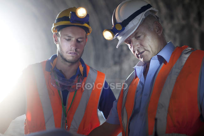 Робітники в каски говорити в тунель — стокове фото